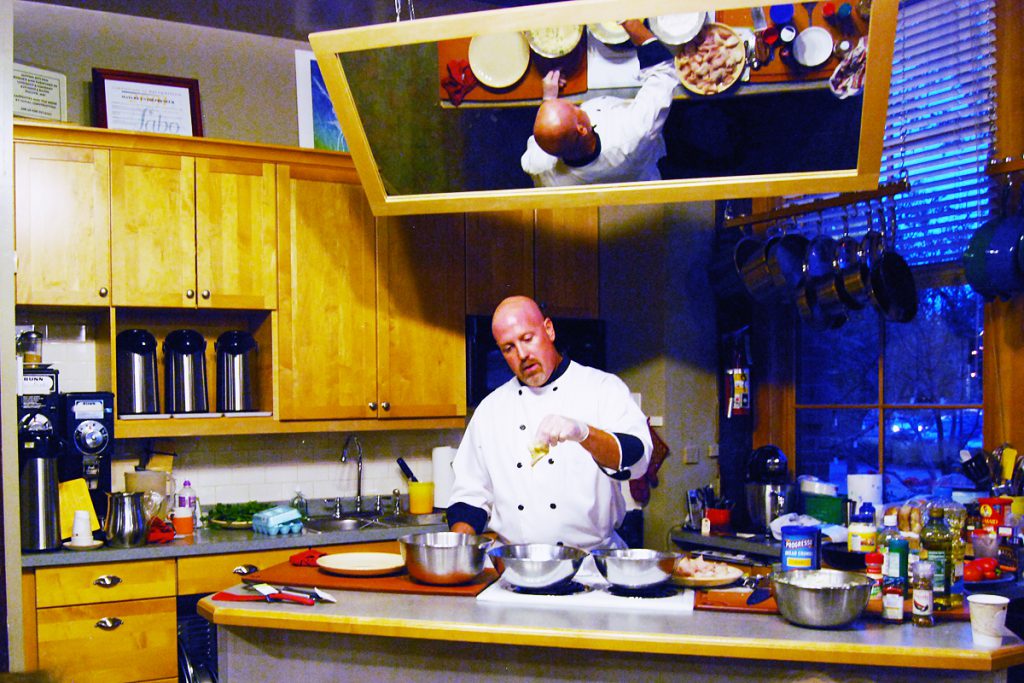 Chef Patrick Moore conducting a fresh fish cooking class at Blue Heron Trading Co.