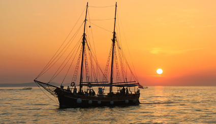 Tall Ship sailing at sunset on the Great Lakes