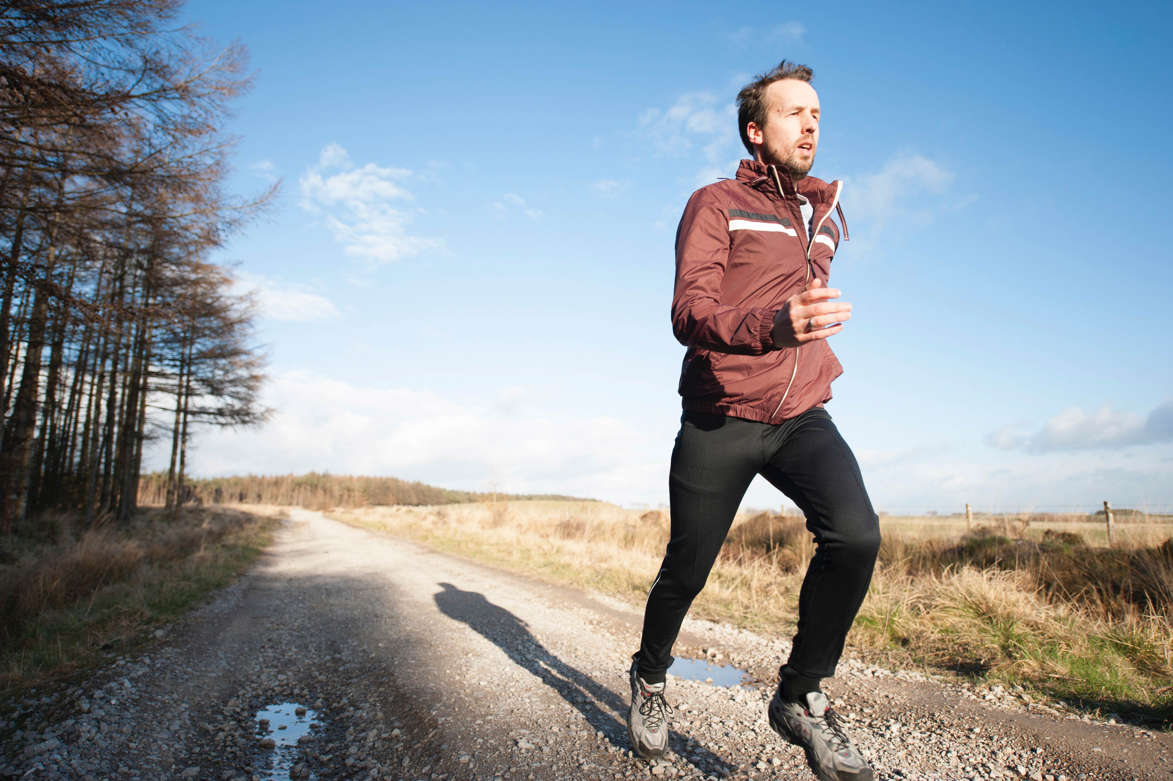 man running on a backroad