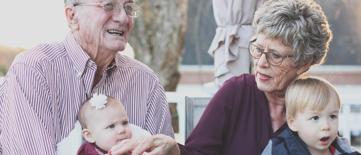 Grandparents holding grandchildren