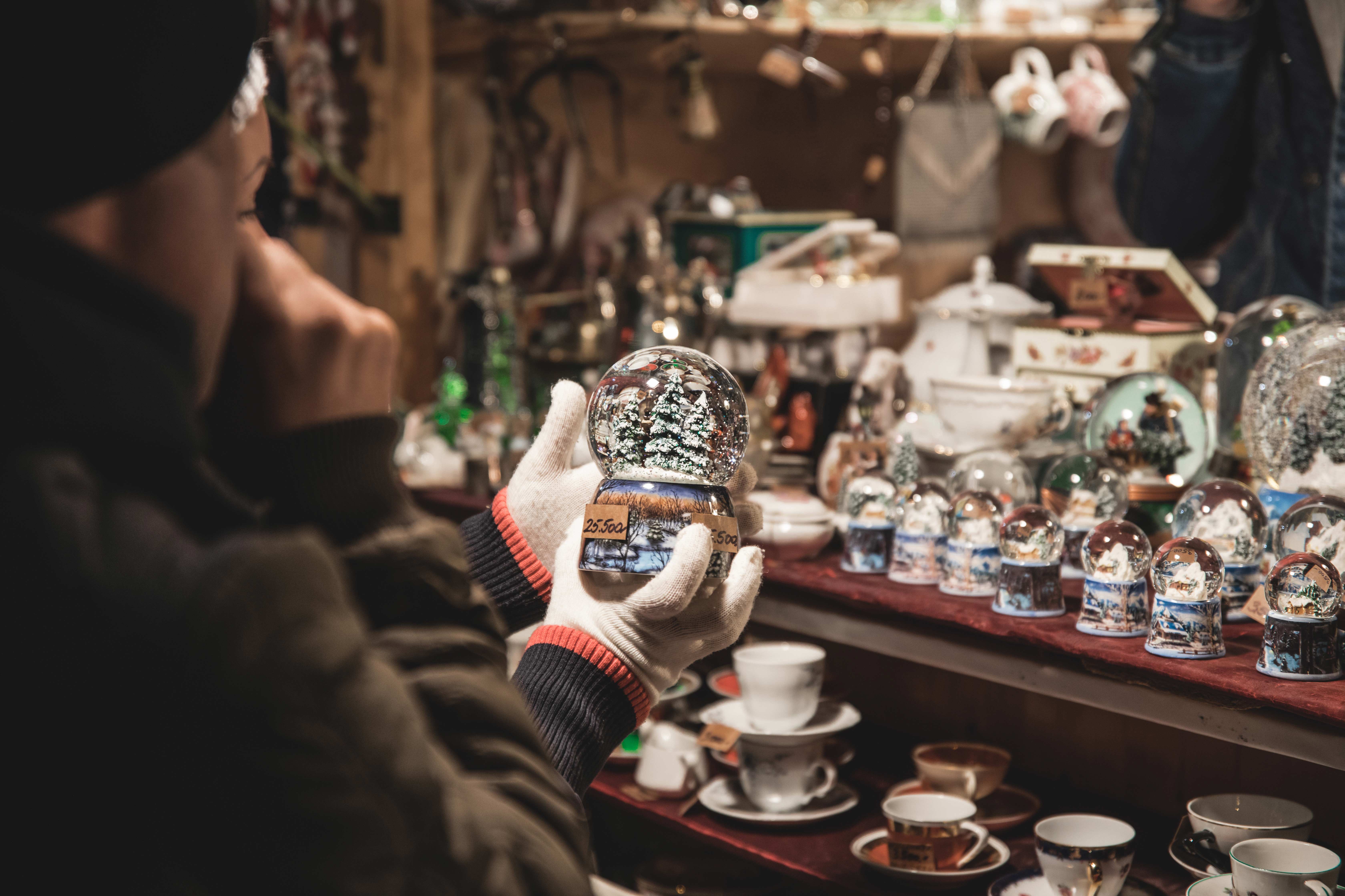 Man shopping looking at a snowglobe