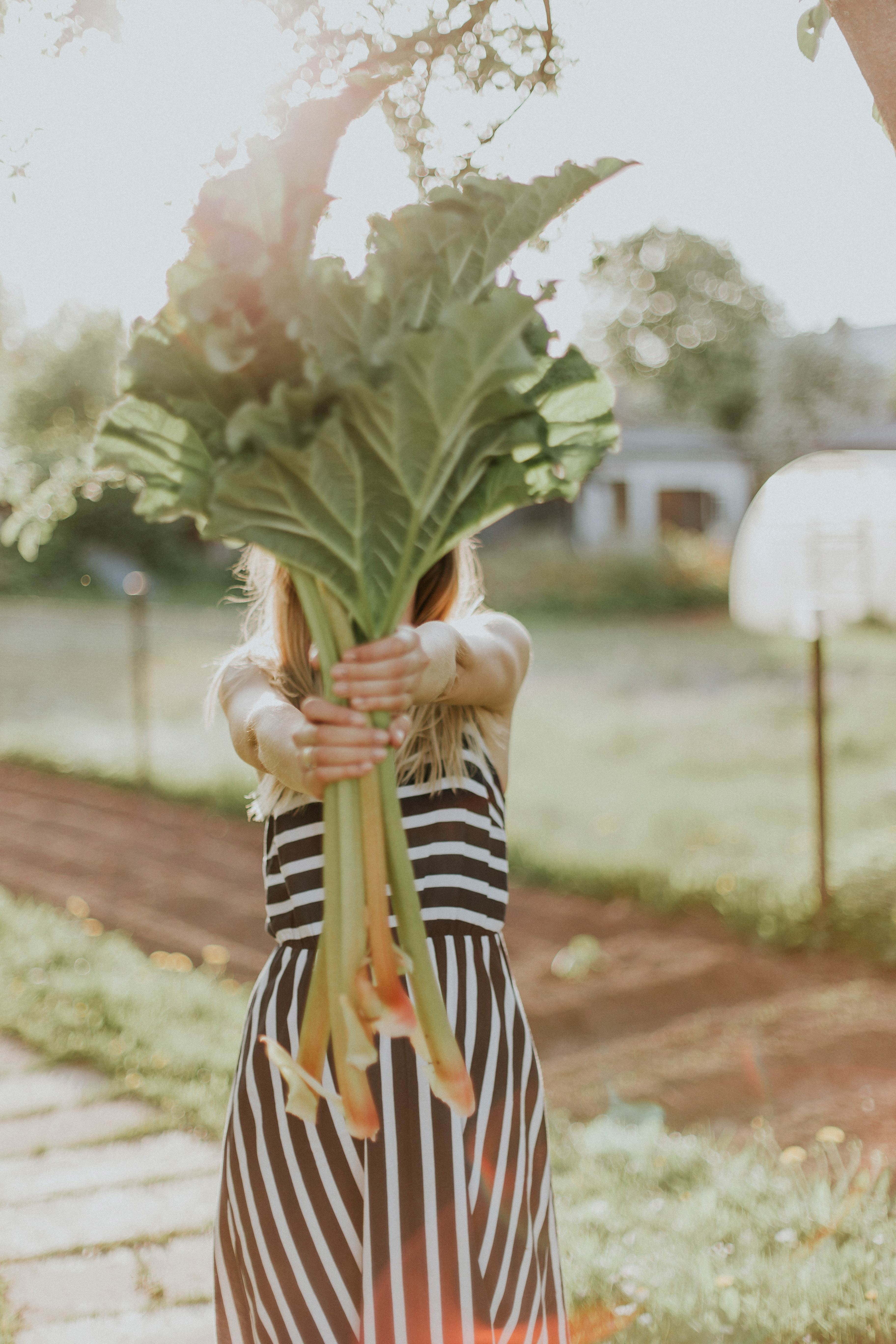 woman holding rhubarb