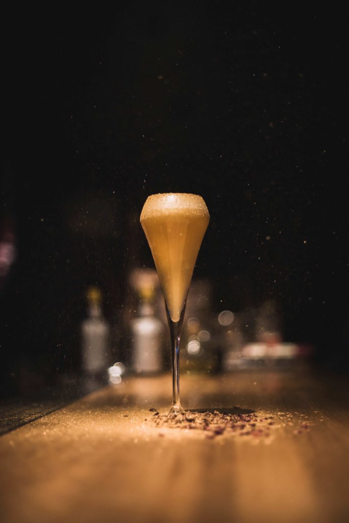 golden cocktail on a bar